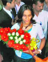Winner of the Indonesian Open, Saina Nehwal being felicitated after her arrival at Rajiv Gandhi International Airport in Shamshabad in Hyderabad on Sunday. 