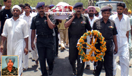 Army officials carrying the body of Iqbal Singh (inset), a soldier, to the cremation ground in Bhagi Vandar village in Bathinda district on Monday.