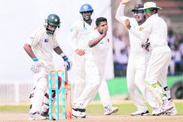 Rangana Herath (C) celebrates the dismissal of Mohammad Yousuf on Tuesday. 