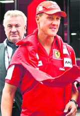 Former F1 World Champion Michael Schumacher walks through the paddock at the Nuerburgring, Germany, during the practice session on Saturday.