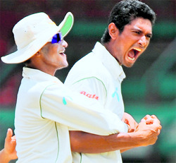 Bangladeshi bowler Mahmudullah (R) celebrates with teammate Shakib Al Hasan during the final day of the first Test match.