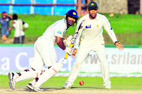 Sri Lankan captain Kumar Sangakkara plays a shot as Pakistan�s Khurram Manzoor looks on during the fourth day of the third and final Test match in Colombo on Thursday.
