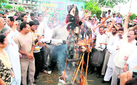 Protesters burn an effigy of DSGMC chief Paramjit Singh Sarna at Ravidass Chowk in Jalandhar on Monday.