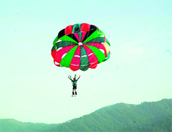 A tourist enjoys parasailing in the Maantalai area of Udhampur district.