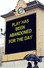 Fans take shelter as play is officially abandoned on the third day of the third Test between England and Australia at Edgbaston in Birmingham on Saturday.