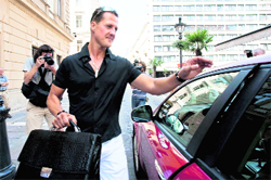 Former seven-time F1 world champion Michael Schumacher gets into his car after visiting Ferrari�s Felipe Massa at Honved Hospital in Budapest on Saturday.