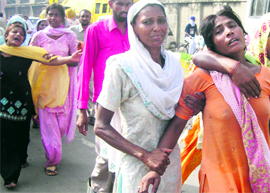 Wailing family members of Mangal Singh, who died while rescuing two colleagues, in Amritsar on Saturday.
