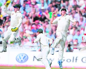 Australian players celebrate the fall of the last England batsman at Leeds