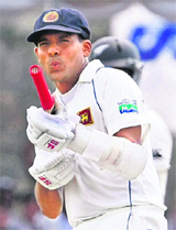 Thilan Samaraweera does a firing action with his bat as he celebrates his century on Wednesday. 