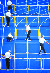 Volunteers replace the hurdles in the track after a heat in the men�s 110 metres hurdles during the World Athletics Championships at the Olympic stadium in Berlin on Wednesday. 