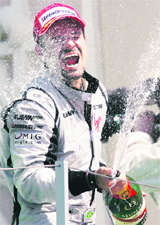Rubens Barrichello celebrates on the podium at Valencia 