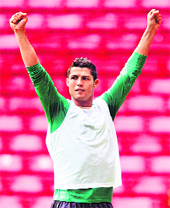 Cristiano Ronaldo raises his arms after scoring on a free kick during a training session in Copenhagen on Friday. 