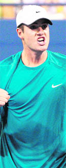 John Isner reacts after a point against Andy Roddick on Saturday.