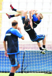 Sweden�s Petter Hansson (top) and Anders Svensson dangle from a crossbar during a soccer training session at the Ta' Qali National Stadium outside Valletta on Monday.