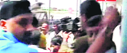 A TV grab of Harbhajan Singh jabbing at a cameraman at the Bangalore International Airport on Wednesday. 