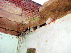 A view of the house where roof of a room caved in at Batala on Sunday.