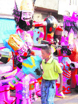 A child carries an effigy of Ravana on the eve of the Dasehra festival in Amritsar