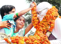 Children garland a statue of Mahatma Gandhi in Jalandhar on Friday
