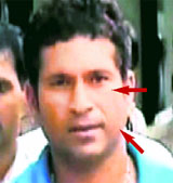 A TV grab shows Sachin Tendulkar arriving at Chatrapati Shivaji International Airport in Mumbai on Friday. Sachin�s left cheek and eye appear swollen.