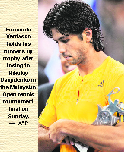 Fernando Verdasco holds his runners-up trophy after losing to Nikolay Davydenko in the Malaysian Open tennis tournament final on Sunday.