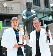 Australia�s captain Ricky Ponting (R) holds the trophy for Leading Run Scorer of the Tournament as Shane Watson holds the ICC Champions Trophy at Nelson Mandela Square in Johannesburg on Tuesday