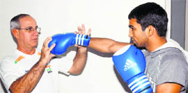 Indian boxing team�s Cuban coach B.I. Fernandez works with Olympian Jitender Kumar in Patiala. 