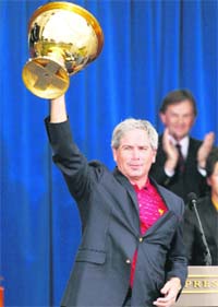 U.S. team captain Fred Couples holds the Presidents Cup after his team defeated the International team in the Presidents Cup golf tournament