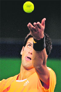 Novak Djokovic serves against Rainer Schuettler in their third round match at the ATP Shanghai Masters tournament on Thursday. Djokovic won 6-4, 6-2.