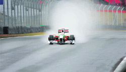 German driver Adrian Sutil powers his Force India under heavy rain during the qualifying session, at the Interlagos racetrack, in Sao Paulo, Brazil