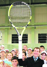 Russian President Dmitry Medvedev holds a giant tennis racket during a visit to a tennis academy in Kazan on Friday.