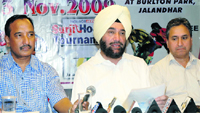 President of Surjit Hockey Society Ajeet Singh Pannu (C) addresses the media in Jalandhar