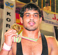 Wrestler Sushil Kumar poses with his medal in Jalandhar on Sunday. 