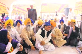 A group of pilgrims from different parts of the world and officials of the Evacuee Trust Property Board of Pakistan inside Gurdwara Nankana Sahib in Pakistan