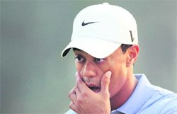 Tiger Woods reacts after sinking a shot on the 18th hole during the second round on Friday.
