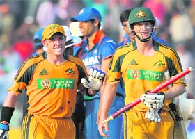 Down under on top: Australian batsmen Michael Hussey (left) and Adam Voges celebrate as they leave the ground after the 6th ODI against India at the Nehru Stadium in Guwahati