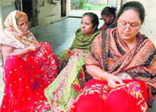 Women artisans embroider attractive patterns in phulkari in Triparhi village near Patiala.