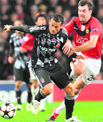 Manchester United�s Darron Gibson (R) and Besiktas Bobo compete for the ball at Old Trafford in Manchester