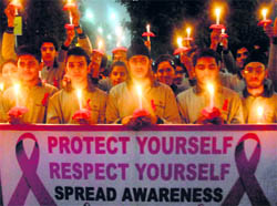 Children hold candles during an AIDS awareness rally on the eve of World AIDS Day at Amritsar on Monday.