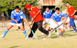 A match in progress between Sansarpur veterans and Army officers of Vajra Corps at Sansarpur hockey ground.