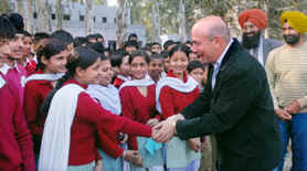 Australian citizen James Anthony Vardanega interacts with the students of Government Secondary School in Puranpur.