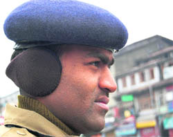 A CRPF jawan wears a headphone-type winter wear on duty in Srinagar. Introduced for the first time in Kashmir, this gear covering just the ears is a rage among people to guard against the winter chill.