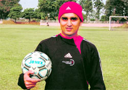 Canada-based soccer coach Sanjeev Parmar at the YFC training ground in Rurka Kalan.