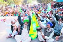 Members of the BKU (Ugrahan) stage a protest at the Primary Cooperative Agricultural Development Bank in Bathinda on Monday. 