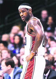 Cleveland Cavaliers forward LeBron James waits during a timeout against the Dallas Mavericks in the first half of their NBA game in Dallas on Sunday