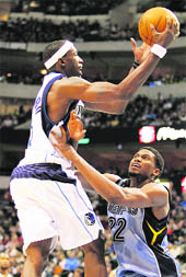 Dallas Mavericks� forward Josh Howard (L) is fouled by Memphis Grizzlies forward Rudy Gay during the second half of their NBA basketball game in Dallas on Saturday.