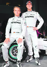 Michael Schumacher (R) and teammate Nico Rosberg pose during the presentation of the new Mercedes GP Petronas Formula 1 team, at the Mercedes Museum in Stuttgart, Germany, on Monday.
