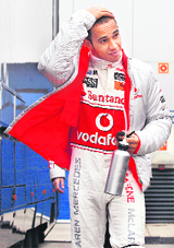 McLaren Formula One driver Lewis Hamilton of Britain walks in the paddock during a training session at the Jerez racetrack in southern Spain on Friday.