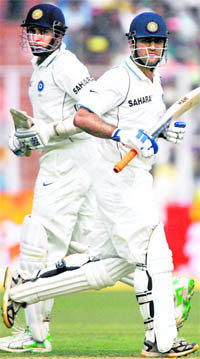 VVS Laxman and MS Dhoni run between the wickets on Tuesday.