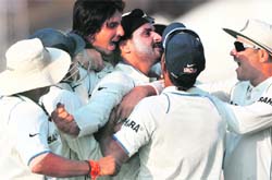 Harbhajan Singh (C) celebrates with teammates after India won the second Test against South Africa in Kolkata on Thursday.