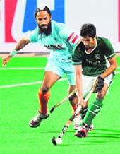 Indian captain Rajpal Singh (L) vies for the ball with Pakistan�s Abdul Haseem Khan during their World Cup match at the Major Dhyan Chand Stadium in New Delhi on Sunday.